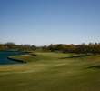 The eighth hole at the Golf Club at Vistoso is a par 4 that wraps around water.