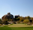 A boulder pile sits behind the par-4 sixth green of the South Course at Boulders Resort. 