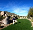 Many tee box locations at the SunRidge Canyon golf course feature large boulders beside them. 