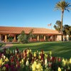 A view of the clubhouse and putting green at 	Rancho de Los Caballeros Golf Club