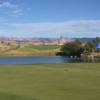 A sunny day view of a hole at Los Lagos Golf Club.