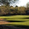 A sunny day view of a hole at San Ignacio Golf Club.