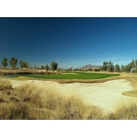 The finishing hole at Ak-Chin Southern Dunes Golf Club has a green that is well protected by bunkers and water.