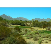 The par-3 fifth hole on the Cholla Course at We-Ko-Pa Golf Club has a green that slopes to the right.